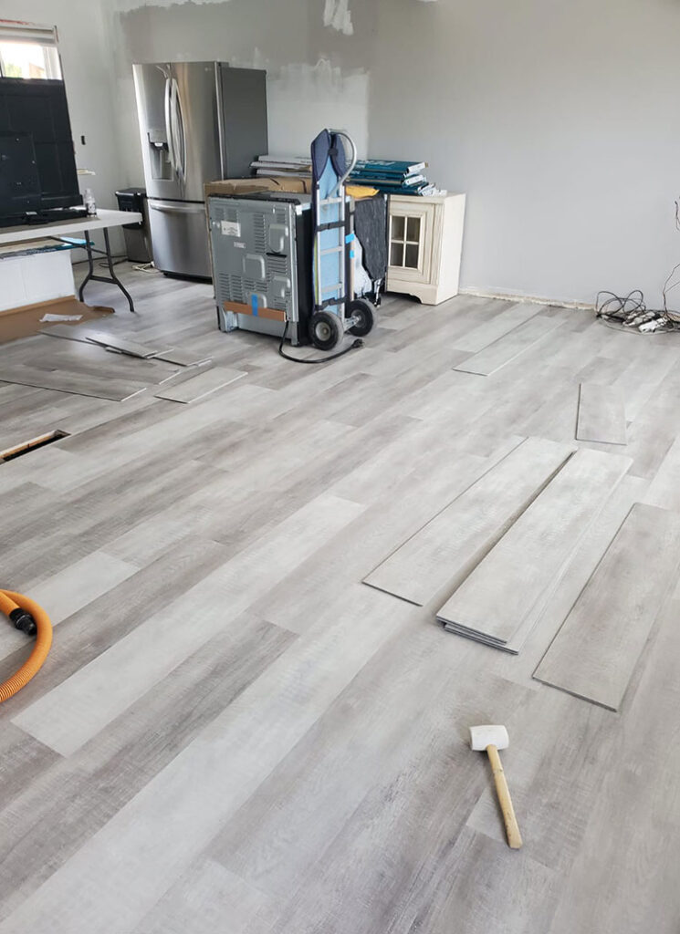 Baker Home Solutions Renovation with photo laying flooring