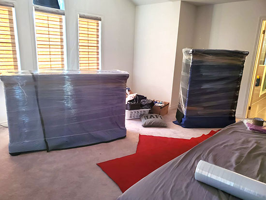 A bedroom after is has been packaged and wrapped for moving day