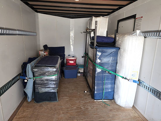 Baker Home Solutions moving truck loaded with matress and bedroom furniture