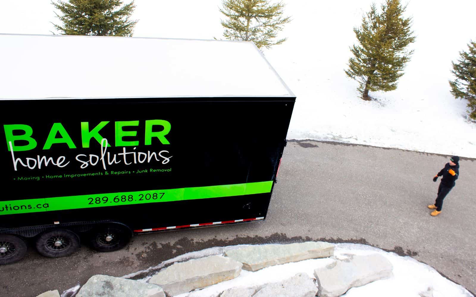 Baker Home Solutions truck parked outdoors with snow, offering home repairs and renovation services.