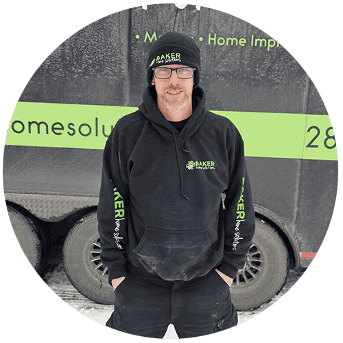 Baker Home Solutions professional home improvement expert in winter gear standing outdoors.