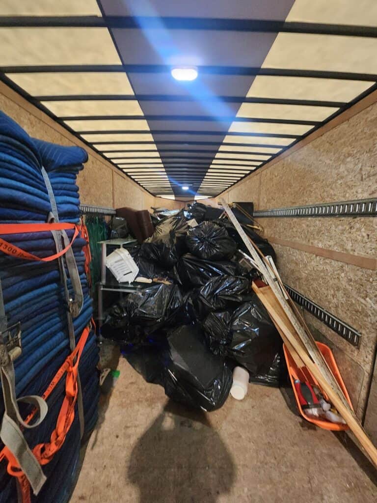 Well-organized garage with stored supplies and cleanup completed by Baker Home Solutions.