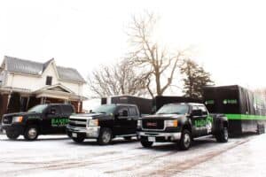 Residential home solutions team vehicles in driveway.
