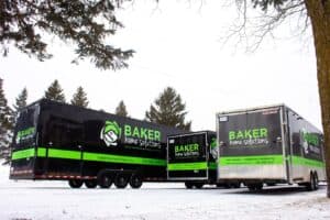 Mobile trailers branded for Baker Home Solutions providing home repair services.