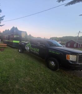 Delivery truck with Baker Home Solutions branding in scenic outdoor setting.