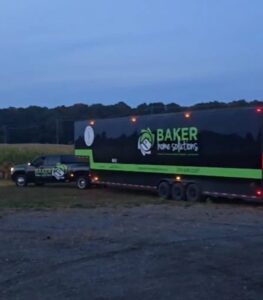 Baker Home Solutions logo on trucks in a rural setting.
