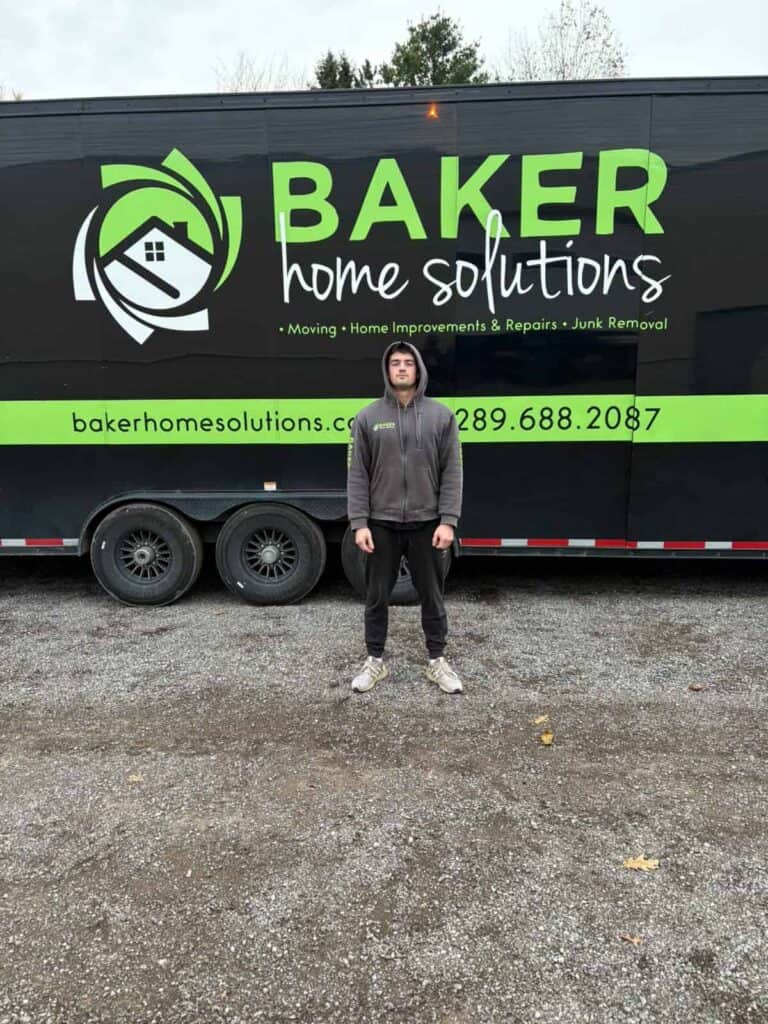 Baker Home Solutions truck with logo and contact info in outdoor setting.